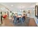 Open-concept dining area with a wooden table, stylish chairs, and a view into the kitchen and living spaces at 512 W Seldon Ln, Phoenix, AZ 85021