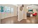 Bright entryway features white door with glass panel, wood floors, and decorative wall hangings at 512 W Seldon Ln, Phoenix, AZ 85021