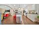 Eat-in kitchen with white cabinets, stainless appliances, dark counters, and view into the living room at 512 W Seldon Ln, Phoenix, AZ 85021