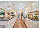 Spacious kitchen with white cabinetry, dark countertops, stainless steel appliances, and an island at 512 W Seldon Ln, Phoenix, AZ 85021