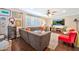 Cozy living room features a large sectional, wood floors, plantation shutters, and ceiling fan at 512 W Seldon Ln, Phoenix, AZ 85021