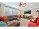 Comfortable living room with a large sectional, custom shutters, and a mounted TV for relaxation at 512 W Seldon Ln, Phoenix, AZ 85021