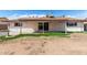 Backyard with a covered patio, block fencing, and low maintenance yard at 5203 W Acoma Dr, Glendale, AZ 85306