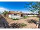 The backyard showcases the home's exterior with a covered patio and space for entertainment at 5203 W Acoma Dr, Glendale, AZ 85306