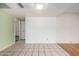 Bright basement area featuring tile flooring and access to another room at 5203 W Acoma Dr, Glendale, AZ 85306