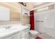 Bathroom with white tiled shower, grab bar, and white vanity at 5203 W Acoma Dr, Glendale, AZ 85306