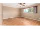 Spacious bedroom with wood floors and a large window offering natural light at 5203 W Acoma Dr, Glendale, AZ 85306