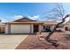 Charming single-story home featuring a well-manicured front yard with desert landscaping at 5203 W Acoma Dr, Glendale, AZ 85306