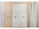 Hallway featuring a spacious white closet with decorative doors at 5203 W Acoma Dr, Glendale, AZ 85306