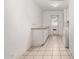 Simple laundry room with tile flooring, white cabinets, and a door to the outside at 5203 W Acoma Dr, Glendale, AZ 85306