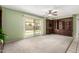 Spacious living room with sliding glass doors to the patio and built-in shelving at 5203 W Acoma Dr, Glendale, AZ 85306