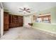 Spacious living room featuring built-in shelving and an open view to the kitchen at 5203 W Acoma Dr, Glendale, AZ 85306