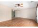 Bright and open living room featuring hardwood floors and access to adjacent rooms at 5203 W Acoma Dr, Glendale, AZ 85306