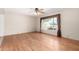 Bright living room featuring hardwood floors, a ceiling fan, and a large window at 5203 W Acoma Dr, Glendale, AZ 85306