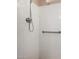Bright shower stall featuring tile, grab bar, and shower head at 5203 W Acoma Dr, Glendale, AZ 85306