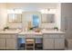 Bathroom featuring a double vanity, updated lighting, and a walk-in shower that creates a spa-like experience at 5401 E Cicero St, Mesa, AZ 85205