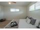Bright bedroom with a ceiling fan, plush carpet, and a comfortable-looking bed and cozy decor at 5401 E Cicero St, Mesa, AZ 85205