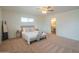 Light and airy bedroom with a comfortable bed, carpet, and access to the en-suite bathroom at 5401 E Cicero St, Mesa, AZ 85205