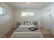 Bright bedroom with neutral walls, plush carpet, and a comfortable-looking bed and end tables at 5401 E Cicero St, Mesa, AZ 85205