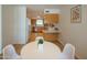 Dining room with a round table and view of the updated kitchen with stainless steel appliances at 5401 E Cicero St, Mesa, AZ 85205