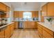 Bright kitchen featuring light wood cabinets, stainless steel appliances, and sleek countertops, ideal for modern living at 5401 E Cicero St, Mesa, AZ 85205