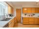 This bright kitchen features sleek quartz countertops, light wood cabinets, and a stainless steel sink at 5401 E Cicero St, Mesa, AZ 85205