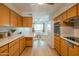 A spacious kitchen leads into a dining area, featuring light wood cabinets and stainless steel appliances at 5401 E Cicero St, Mesa, AZ 85205