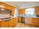 Well-lit kitchen showcases light wood cabinets, stainless steel appliances, and quartz countertops for a modern appeal at 5401 E Cicero St, Mesa, AZ 85205