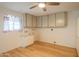 Well-lit laundry room featuring wood floors, ample storage space, and modern brickwork at 5401 E Cicero St, Mesa, AZ 85205