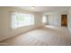 Spacious living room with plush carpet, large windows and neutral colors, creating a cozy atmosphere at 5401 E Cicero St, Mesa, AZ 85205