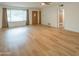 Bright living room with gleaming hardwood floors, large windows, and a welcoming front door at 5401 E Cicero St, Mesa, AZ 85205
