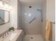 Contemporary walk-in shower highlighted by neutral gray tiling, a grab bar, and modern showerhead at 5401 E Cicero St, Mesa, AZ 85205