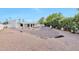 Expansive backyard featuring desert landscaping, mature trees, and a covered patio at 5564 N 77Th Pl, Scottsdale, AZ 85250