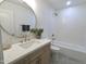 Updated bathroom with a vanity, gold fixtures, and a tub with a tiled shower at 5564 N 77Th Pl, Scottsdale, AZ 85250