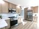 Updated kitchen with stainless steel appliances, white counters, and light wood cabinets at 5564 N 77Th Pl, Scottsdale, AZ 85250