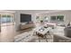 Bright living room with modern furniture, large TV, and sliding doors to the outdoor space at 5564 N 77Th Pl, Scottsdale, AZ 85250