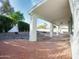 Spacious covered patio with red brick flooring, offering serene views of the landscaped backyard at 5564 N 77Th Pl, Scottsdale, AZ 85250