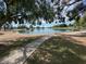 Scenic view of a community pond with a paved walkway and grassy surroundings at 5564 N 77Th Pl, Scottsdale, AZ 85250