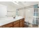 Well-lit bathroom with a large mirror, wood vanity, and shower-tub combination at 6539 W Briles Rd, Phoenix, AZ 85083