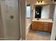 Well-lit bathroom featuring a walk-in shower, soaking tub, and double vanity sinks at 6539 W Briles Rd, Phoenix, AZ 85083