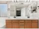 Bathroom featuring a dual sink vanity, framed mirror, and lighting at 6539 W Briles Rd, Phoenix, AZ 85083