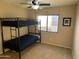 Bunk beds in a well-lit bedroom featuring a ceiling fan and neutral carpeting at 6539 W Briles Rd, Phoenix, AZ 85083