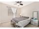Comfortable bedroom featuring carpet floors, a ceiling fan, and a well-lit nightstand at 6539 W Briles Rd, Phoenix, AZ 85083