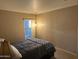 Neutral-toned bedroom offering a queen-sized bed, carpeted floors, and large window at 6539 W Briles Rd, Phoenix, AZ 85083