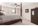 Bedroom with four poster bed, ceiling fan, and safe at 6539 W Briles Rd, Phoenix, AZ 85083