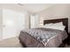 Neutral bedroom featuring carpet floors, a view into the bathroom, and a comfortable bed at 6539 W Briles Rd, Phoenix, AZ 85083