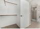 Walk in closet leading to bathroom with carpet, neutral walls, and shelving at 6539 W Briles Rd, Phoenix, AZ 85083