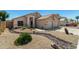 Beautiful home features a two-car garage, desert landscaping and unique rock drainage at 6539 W Briles Rd, Phoenix, AZ 85083