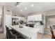 Bright kitchen featuring a large island with a waterfall countertop and stainless steel appliances at 6539 W Briles Rd, Phoenix, AZ 85083