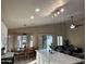Open-concept kitchen and dining area with pendant lighting, seamless access to living area, and neutral finishes at 6539 W Briles Rd, Phoenix, AZ 85083